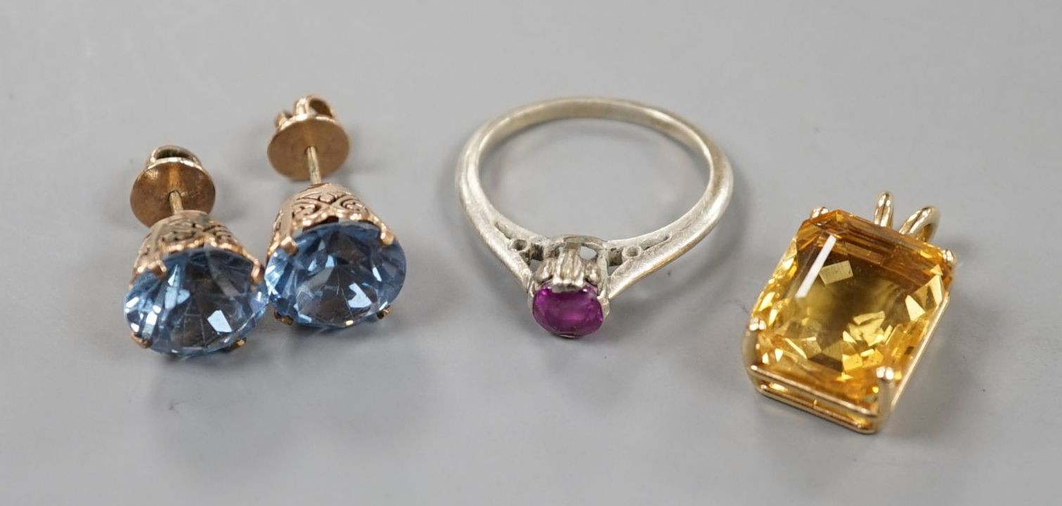 A yellow metal and citrine set pendant, overall 20mm and three other items including a pair of ear studs.